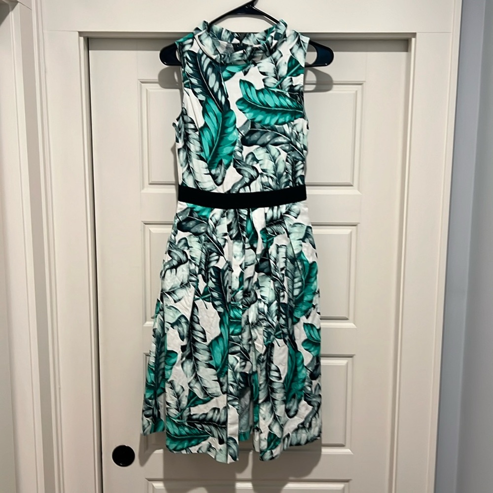 High neck dress. Below the knee. Pockets! Front has a flap - Perfect for spring.